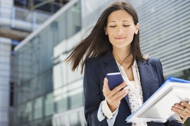 Businesswoman using cell phone in office